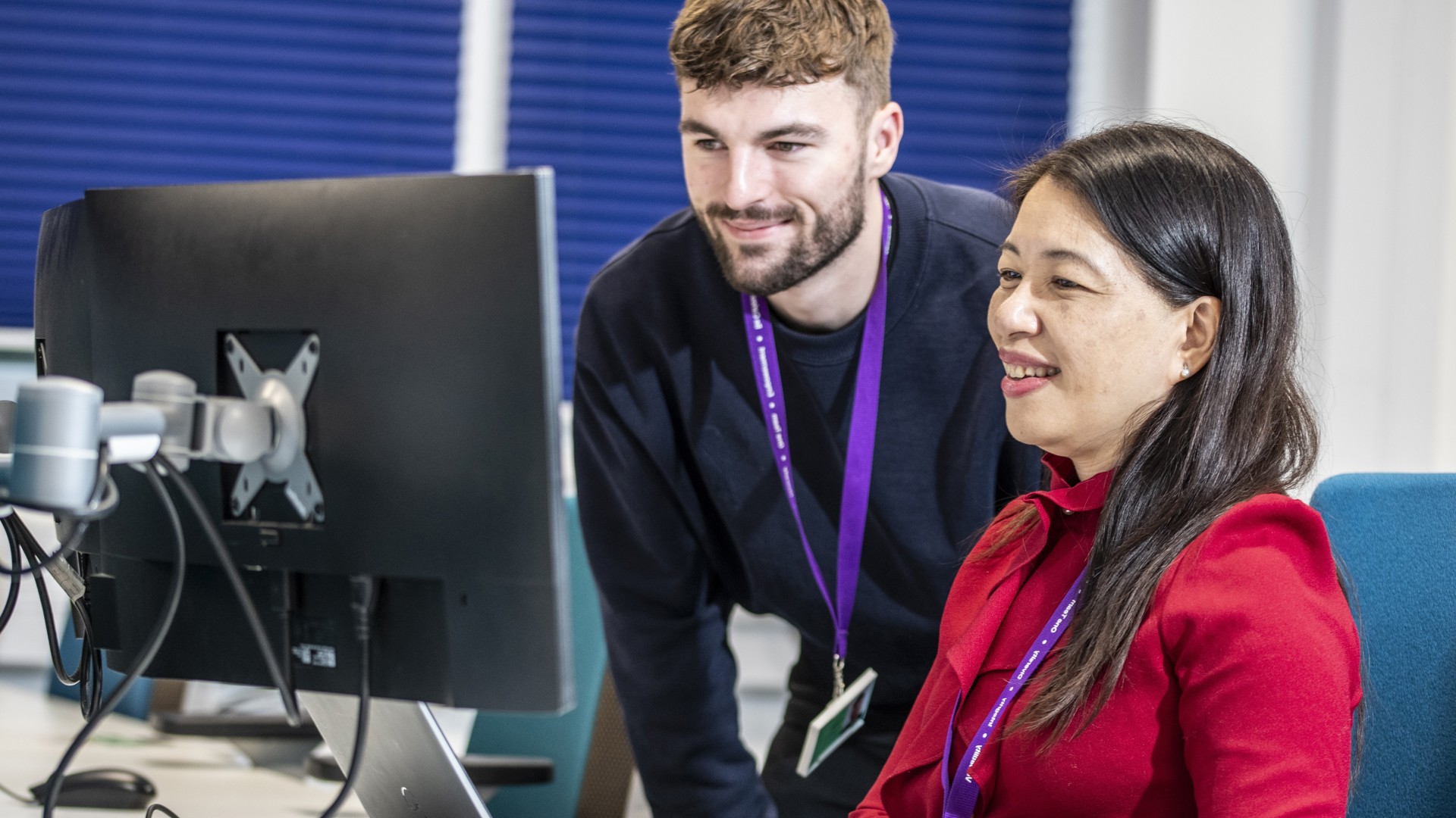 Finance employees working together at laptop